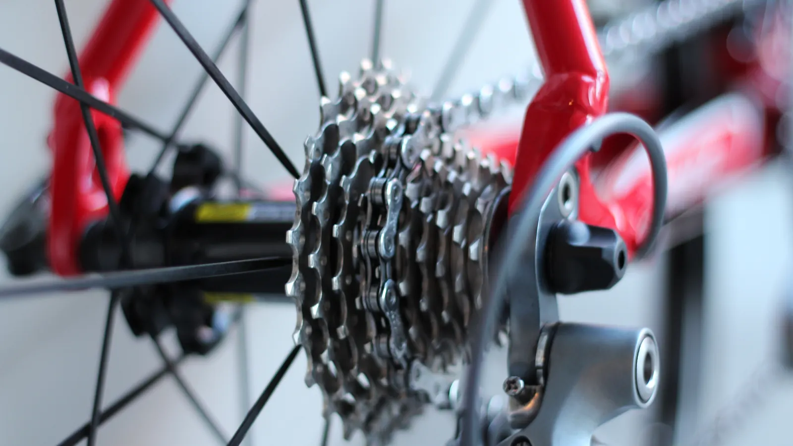 Close-up of the rear gears and chain on a red bicycle