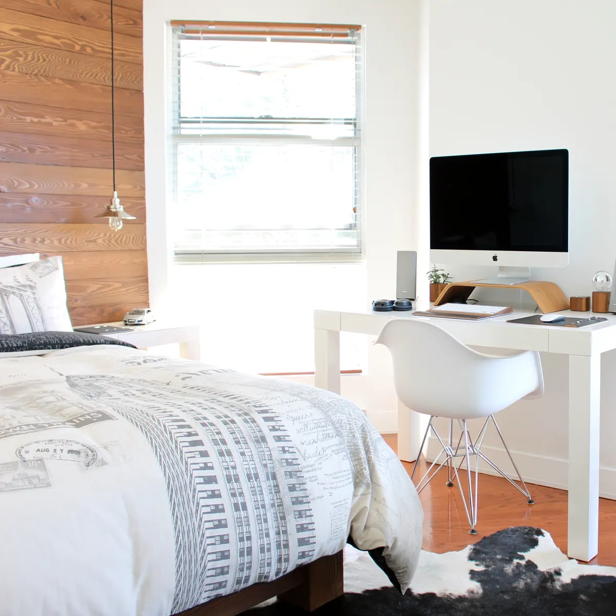 A neatly made bed in a bright bedroom