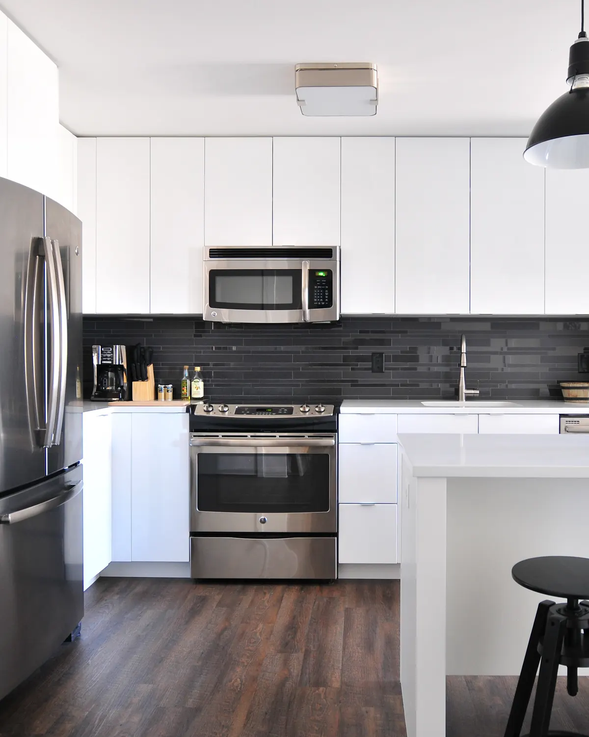 A bright, tidy kitchen with white cabinets and counters